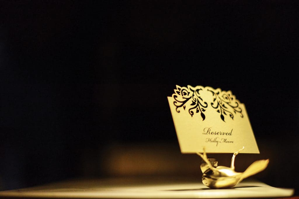 A golden tufted titmouse by Sparrow holds a
reserved card on a table in the restaurant.