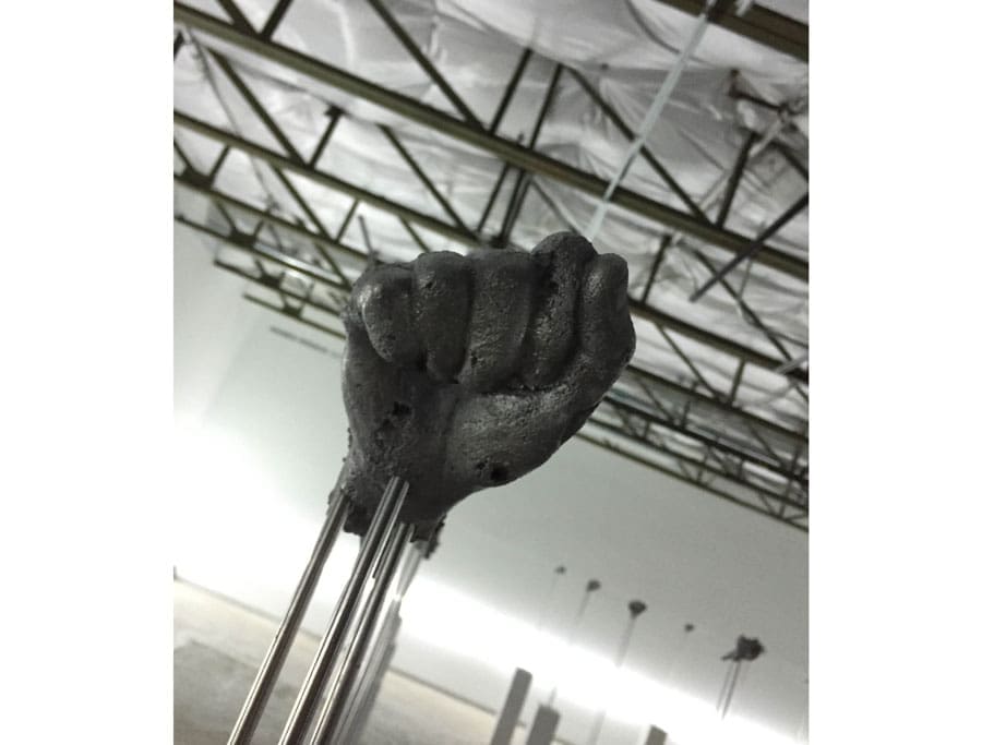 An enigmatic fist, one of many, rises in the Haines Riddick Gallery of the epic Loris Gréaud installation.