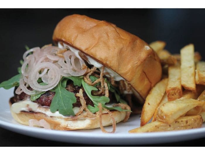 The Juicy Lucy at Lowbrow. Trill Texas angus beef
stuffed with jalapeños and fontina cheese, topped with arugula, crispy shallots and pickled shallots on 
Slowdough challah bun. 