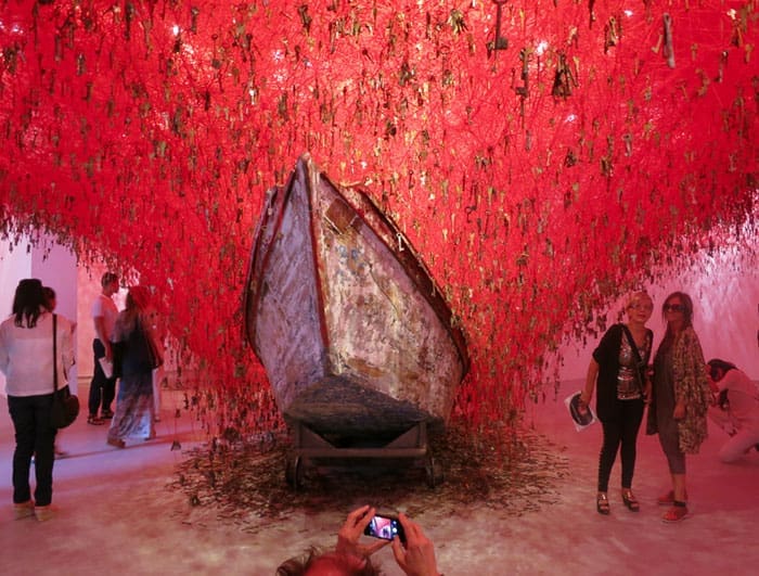 Japanese Pavilion, Giardini: Chiharu Shiota's “The Key in the Hand.”
The artist creates this large-scale installation using several thousand strings of red yarn tied to keys, symbolizing the safeguard of our memories being stored behind the protection of the key to our true feelings. The two boats beneath the keys are meant to capture the rain of memories. One of my favorites.
