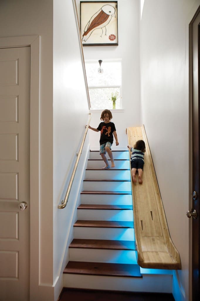 The stair slide was handcarved by Sam Jones
from old bowling-alley
floors. The copper handrail matches a sliding fire pole in the playroom.