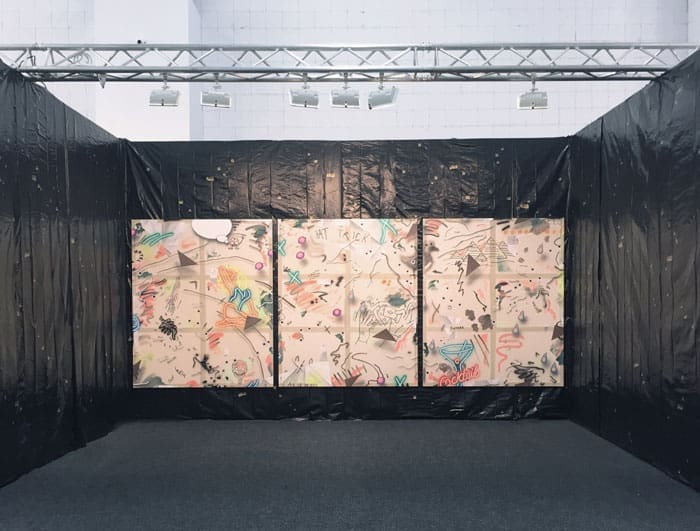 Dallas native-turned-New Yorker Josh Reames at Johannes Vogt, NADA New York juxtaposed paintings with a tarp and bullet hole decals. 