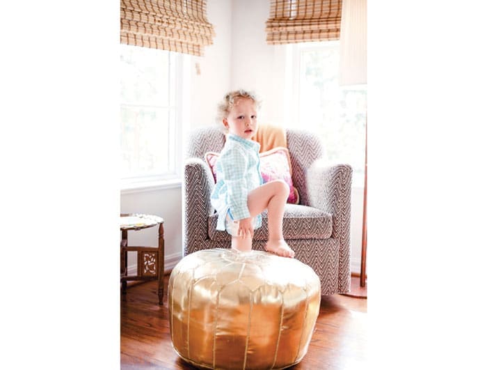 Charlie in his bedroom. Gold Moroccan pouf and Moroccan table are vintage. The chair is covered in vintage fabric found at First Monday at Canton. Hand-embroidered pillow from Anthropologie.