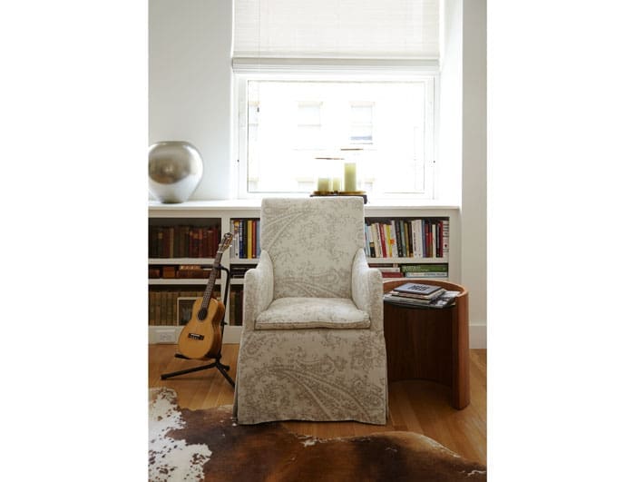 A chair upholstered in Peacock Alley linen fabric. Walnut side table purchased from the Peacock Alley showroom. The ukulele belongs to John Bitzer.
