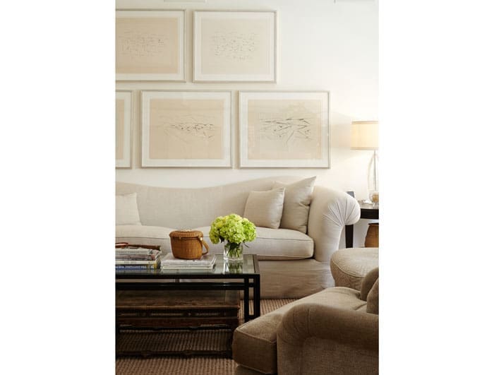 A detail of the main living area includes a collection of artworks from Santa Fe that belong to John Bitzer. A contemporary coffee table is paired with an antique Chinese table. 