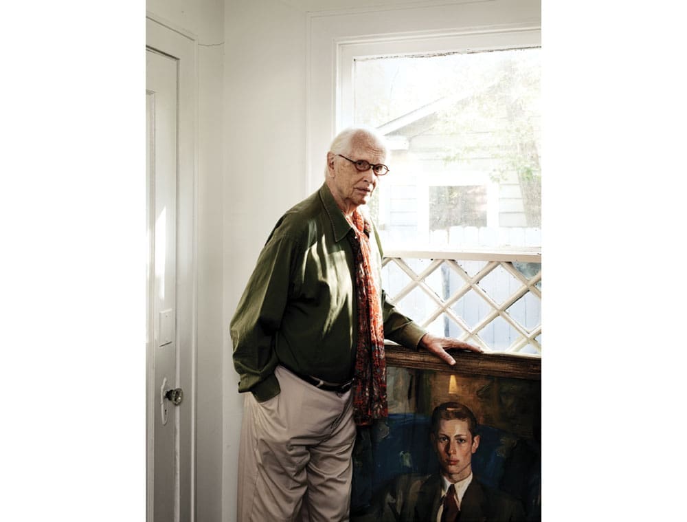 Fred Baldwin with a portrait of himself at age 18, painted by American artist Louis Betts.