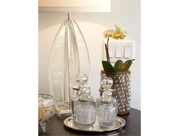 The midcentury Lucite lamp is an antiques store find. The crystal and silver decanters are from a Paris flea market. The vase is from Cebolla Fine Flowers.