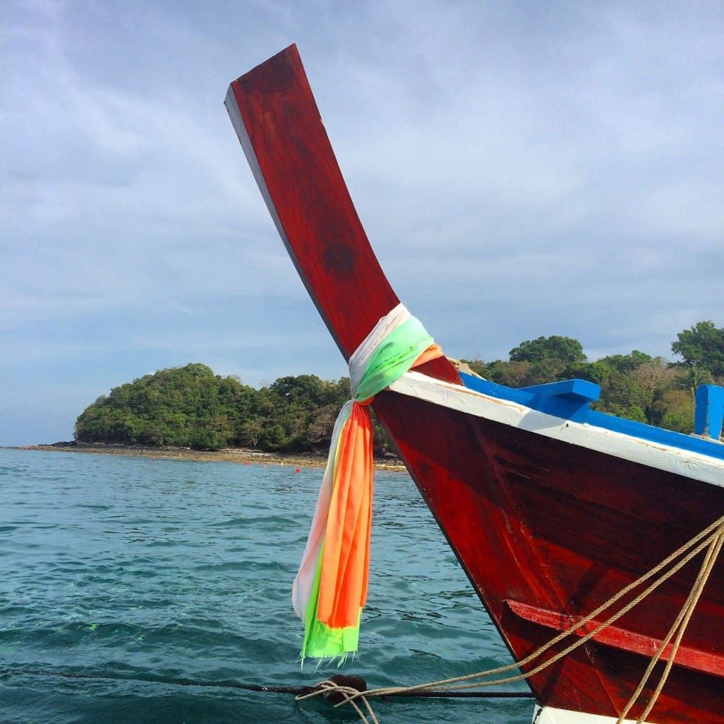 Vibrant traditional adornment on the bow of a long tail boat.