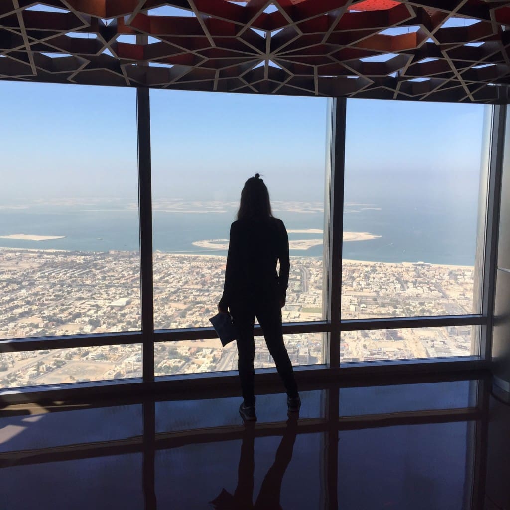 Standing atop the world's highest building, Burj Khalifa in Dubai, on the 125th floor.