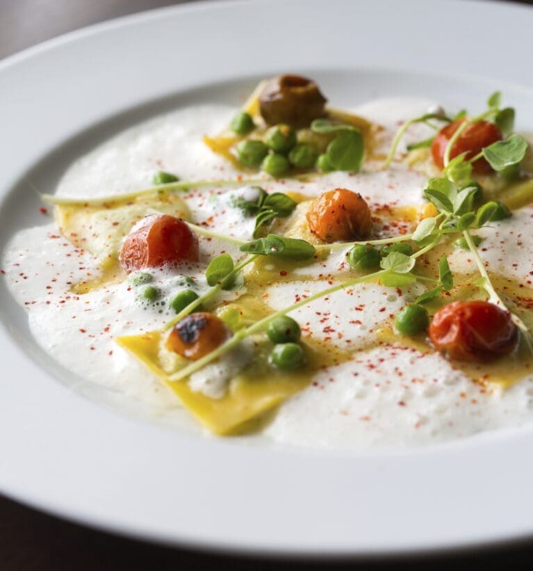 TABLE’s Spring Pea Ravioli, available on the HRW dinner menu.
The dish includes cherry tomatoes, pea shoots, fresh mint, and parmesan broth. 