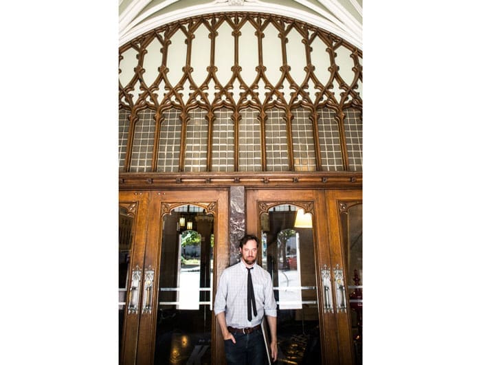 The artist exits the historic Kirby building, in the heart of downtown Dallas' Main Street District.