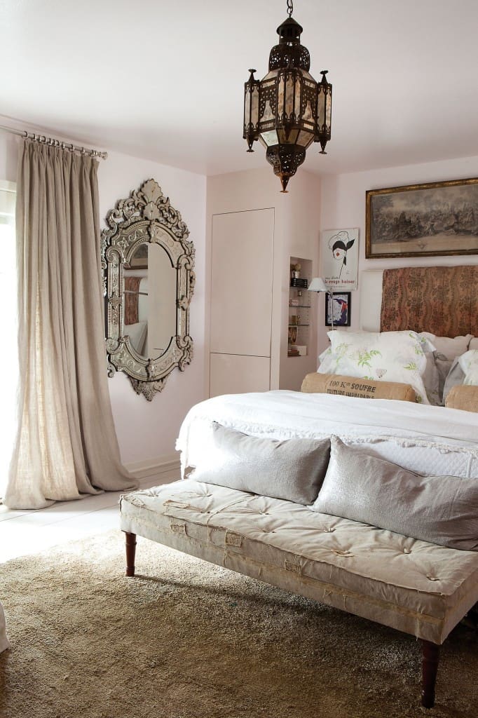 Cathy Echols' master bedroom with antique Venetian mirror and Moroccan light fixture, and the palest of pink walls. 