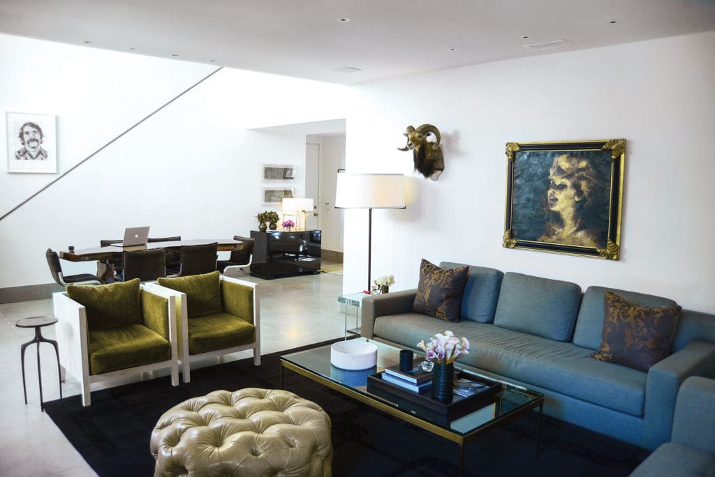 In Brant McFarlain's living room, a pouf designed by McFarlain was fabricated locally. Zographos coffee table. Jean Michel Frank for Julian Chichester chairs in Pierre Frey mohair. Taxidermy mouflon. Holly Hunt sofa. Tony Sherman artwork.