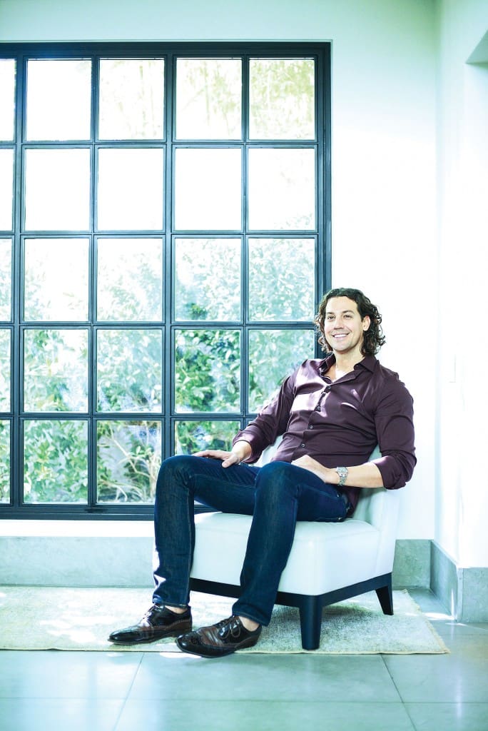 McFarlain relaxes in the vestibule near his kitchen. Christian Liaigre chair. Oushak rug from Abrash.