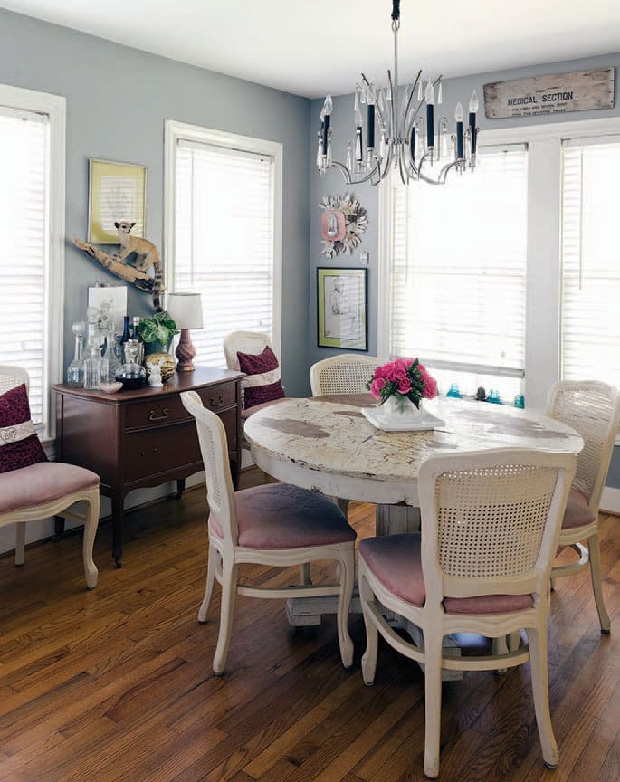 Vintage German Art Deco crystal chandelier hangs above a dining-room table
and chest inherited from Sensabaugh’s grandparents. Vintage cane-back chairs from a Houston estate sale. Antique medical sign from Fort Sam Houston. Flowers by Sensabaugh.