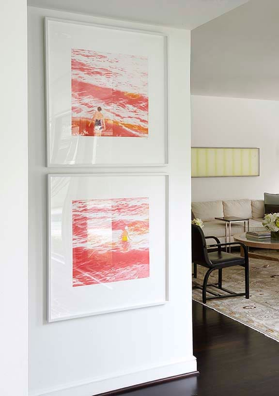 Pair of artworks on the wall by Isca Greenfield- Sanders, daughter of artist Timothy Greenfield-Sanders. In the TV room beyond, artwork above the sofa is by McKay Otto, a gift from the artist. The black chairs are by Art Deco designer Gilbert
Rohde, which Smith has
owned since age 15.