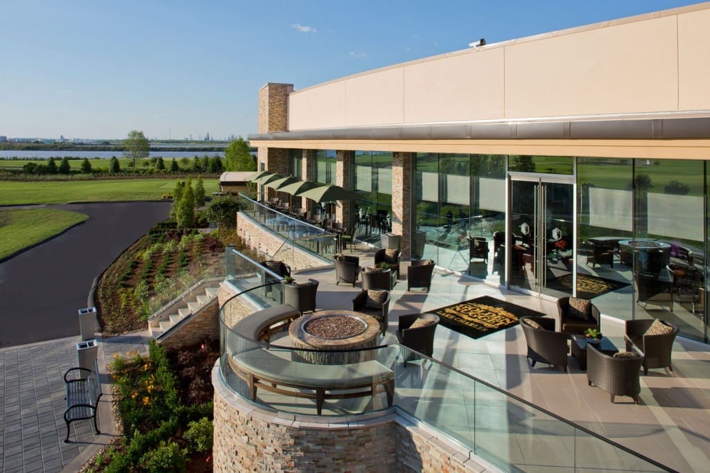 An al fresco bar bordered by fire pits leads to the bayside beach front. 