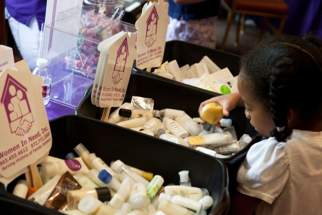 Kids Give volunteers assemble care kits for victims of domestic violence.