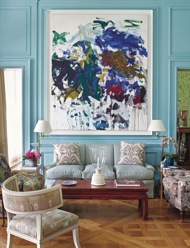 The strong color in this living room in a Long Island home is an exciting background for the Joan Mitchell painting. (Photography by Fritz von der Schulenberg)