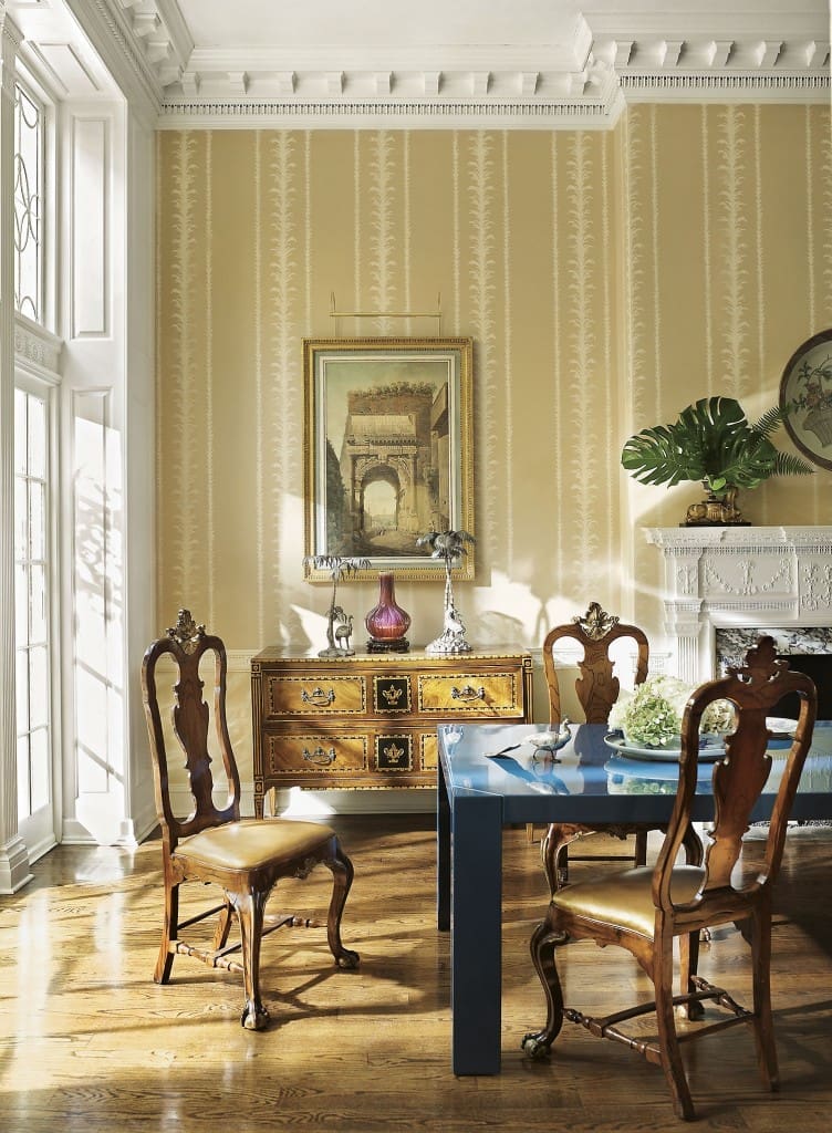 To center a dining room in a 19th-century house, a Karl Springer table from the 1970s was lacquered blue and paired with a set of Portuguese chairs. (Photography by Pieter Estersohn)