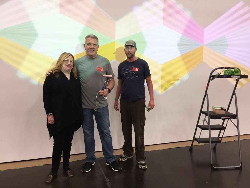 Jay Shinn (middle) and dealer Barbara Davis bask in his light installation.