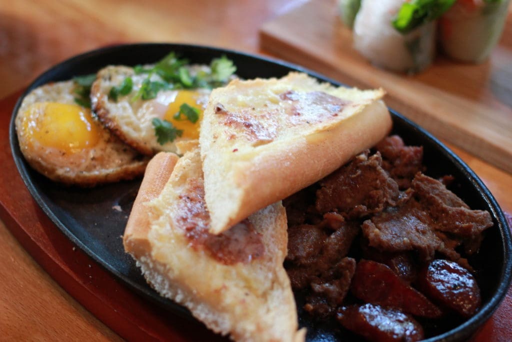 The steak and eggs also includes Vietnamese sausage and a buttered baguette with bone marrow pâté. 