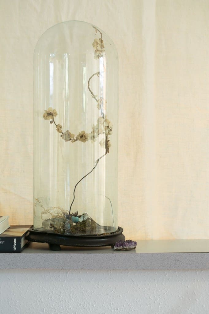 Victorian cloche from
August Antiques holds
a wire branch with
millinery flowers.