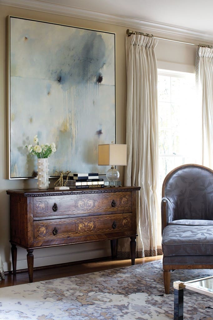 A moody Steven Seinberg painting from Søren Christensen Gallery in New Orleans; antique Italian console from Area. Silk taffeta custom curtains with Samuel & Sons Greek-key trim.
