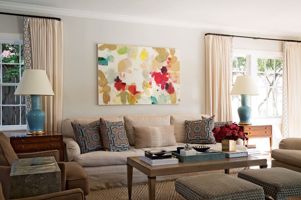 A painting by Meredith Pardue from Laura Rathe Fine Art was the starting point for the living room, one of the first rooms Looke decorated. Christopher Spitzmiller lamps.  Coffee table by Hickory Chair. X benches upholstered in a geometric Osborne & Little fabric. Holland and Sherry and Manuel Canovas pillows. Silk curtains with Mary McDonald for Schumacher trim.