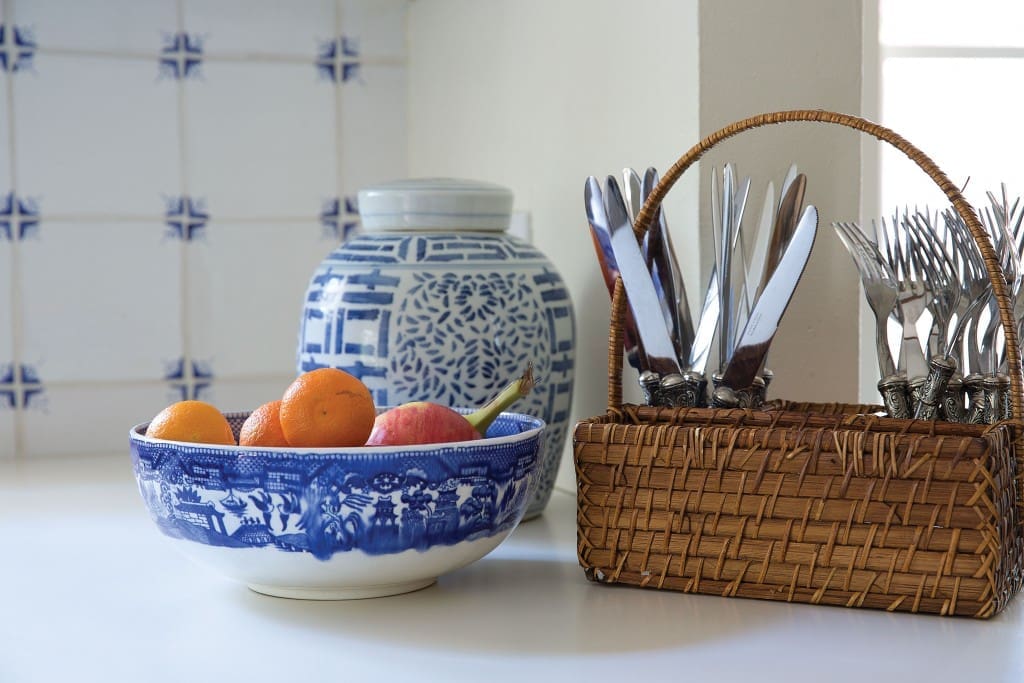You don’t have to start over to make a design work for you. The yellow-and-blue country French look of the kitchen wasn’t her style, but Looke didn’t want to undertake a full kitchen renovation. Instead, she splurged on new appliances and painted over the yellow walls in bright white, embracing the blue-and-white scheme. 
