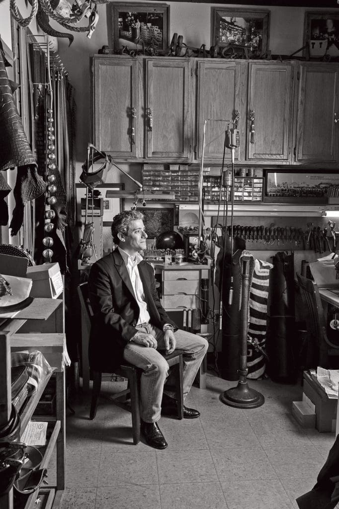 Jason Maida in his workshop, a room filled with leather and metal and history.