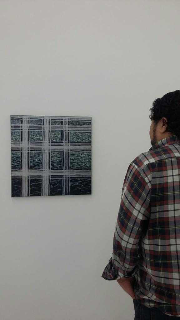 Gallerist Arturo Palacios contemplates an untitled work by Williams, circa 2012. 