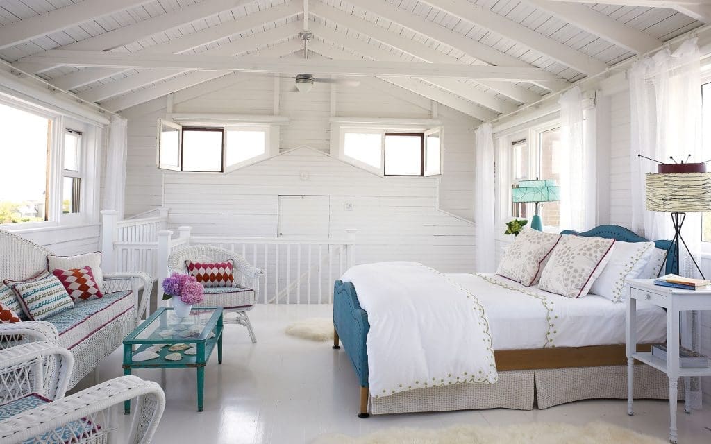 Poppi’s bedroom in the winterized attic. The white wicker furniture came with the house. Lamps and bed are eBay finds.