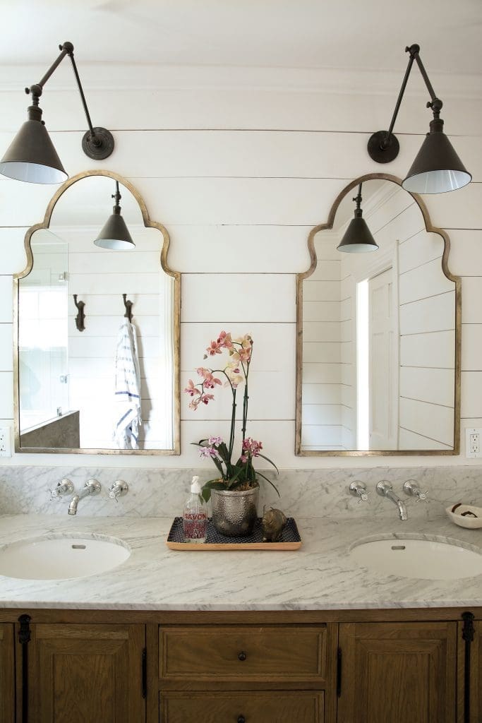 The renovated master bath with shiplap walls, Carrera marble countertop and
Hansgrohe faucets.
