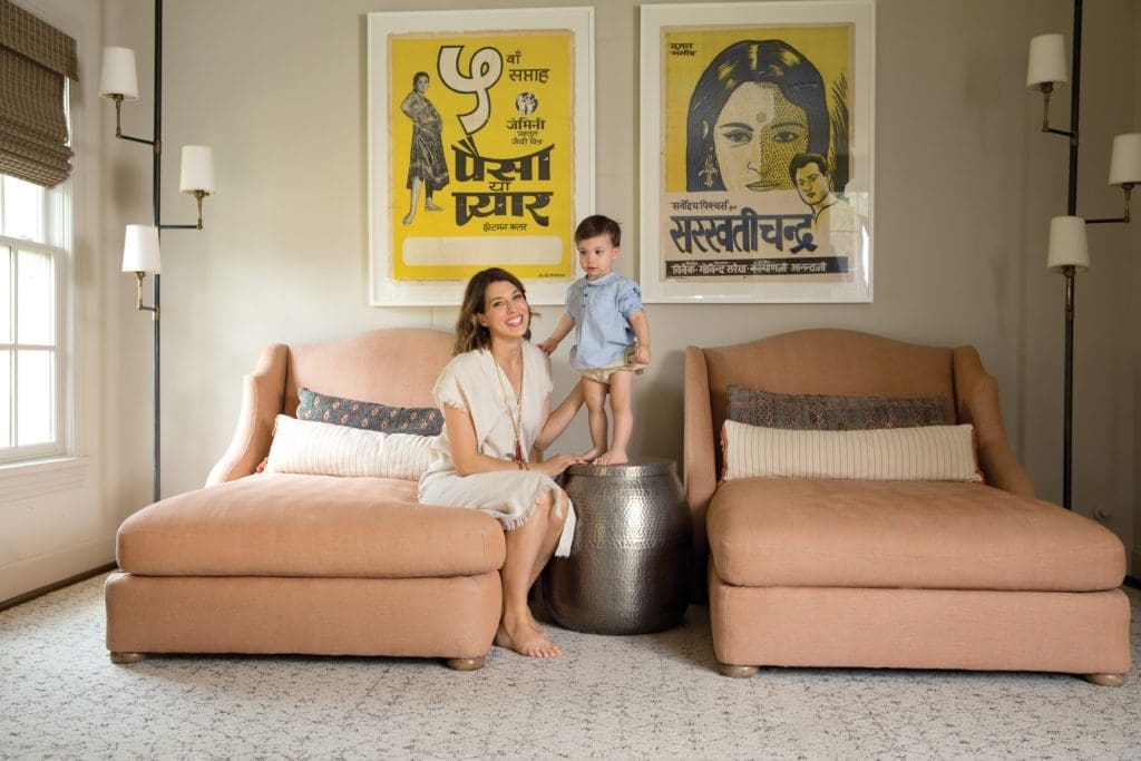 Barton and Theo in the family room with a pair of Lee Industries chaises under
vintage Bollywood posters.