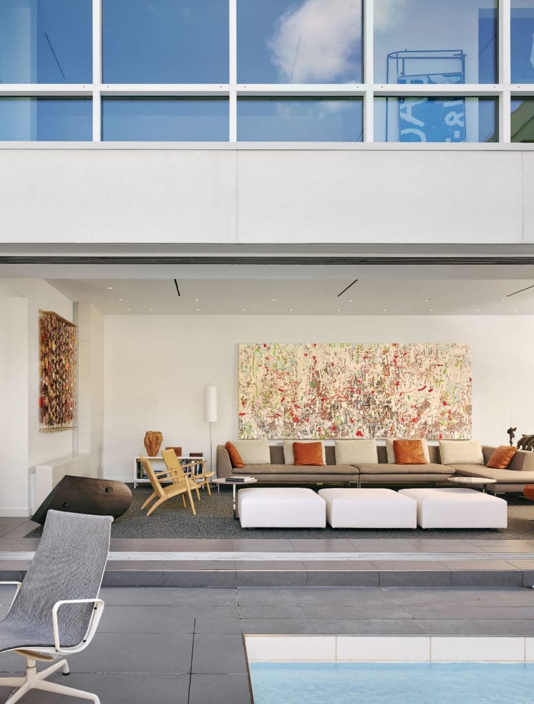 The living room, as seen from the courtyard, with sliding doors open. B&B Italia sofa and Minotti ottomans, all from
Internum. Vintage 1950s Hans Wegner armchairs. Over the sofa, Amy Ellingson’s "Variation (accumulation)," 2013, a
commission. The sculpture is Steve Murphy’s "Untitled," 2011.