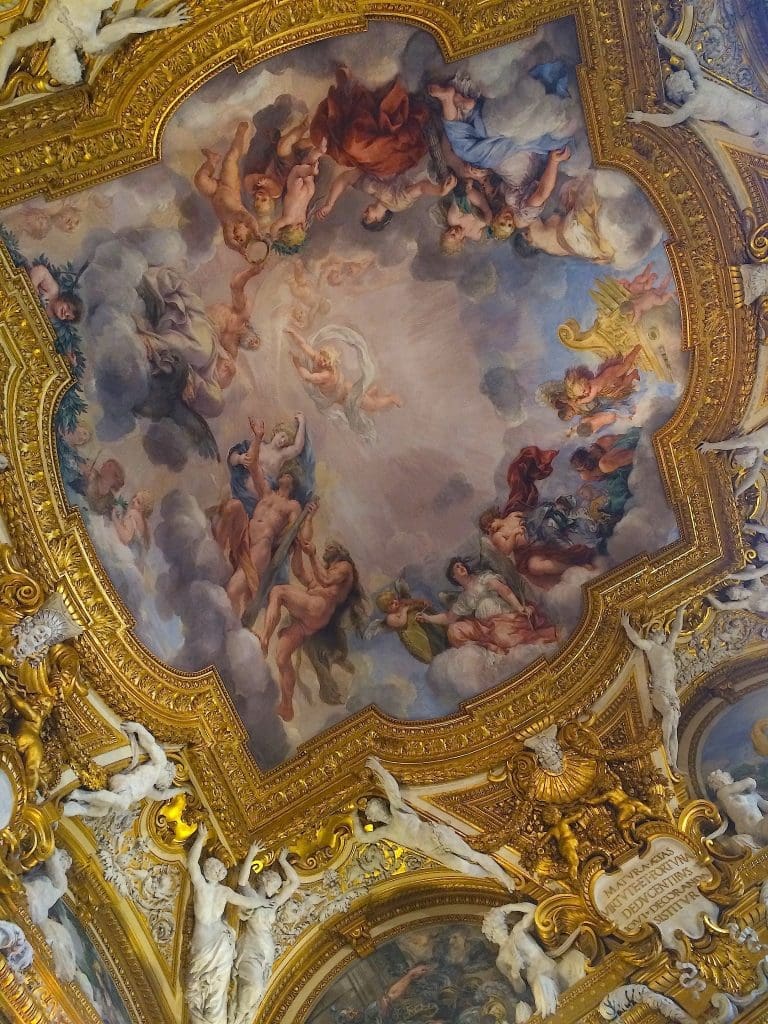 Baroque ceiling fresco with gilded and white stuccoes.