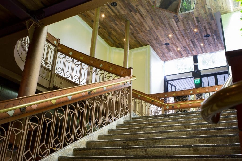 A grand staircase leads patrons down from street level. 
