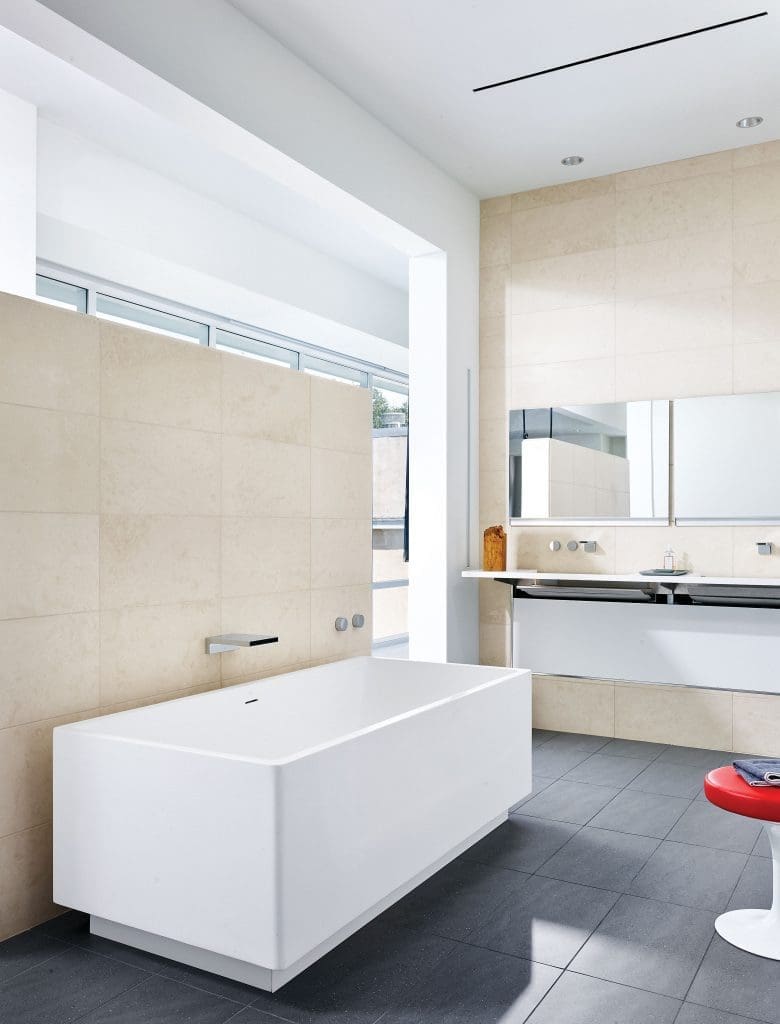 In the master bath, a resin tub by Blu Bathworks, Vancouver, and Caesarstone sink with hidden pipes from Australia. Dornbracht fixtures.
