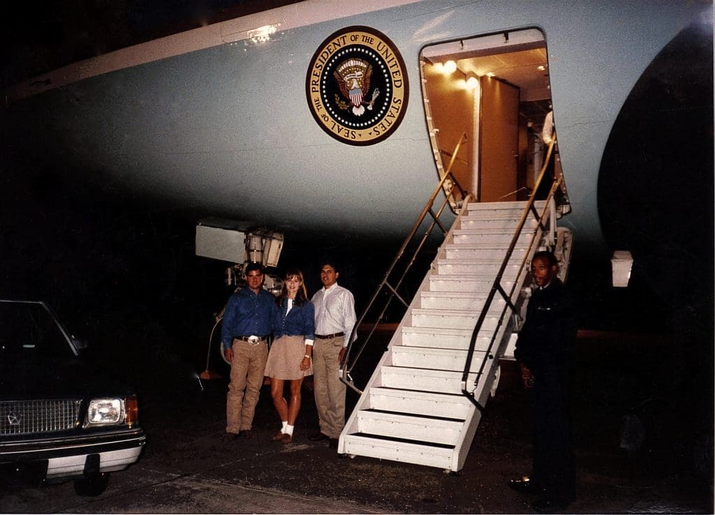 Roberto, Erica, and Raul Molina stand in front of Air Force One. 