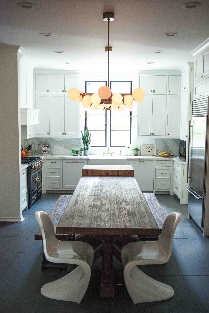 In the kitchen, Wisteria farm table and vintage Verner Panton chairs; Arteriors Home chandelier