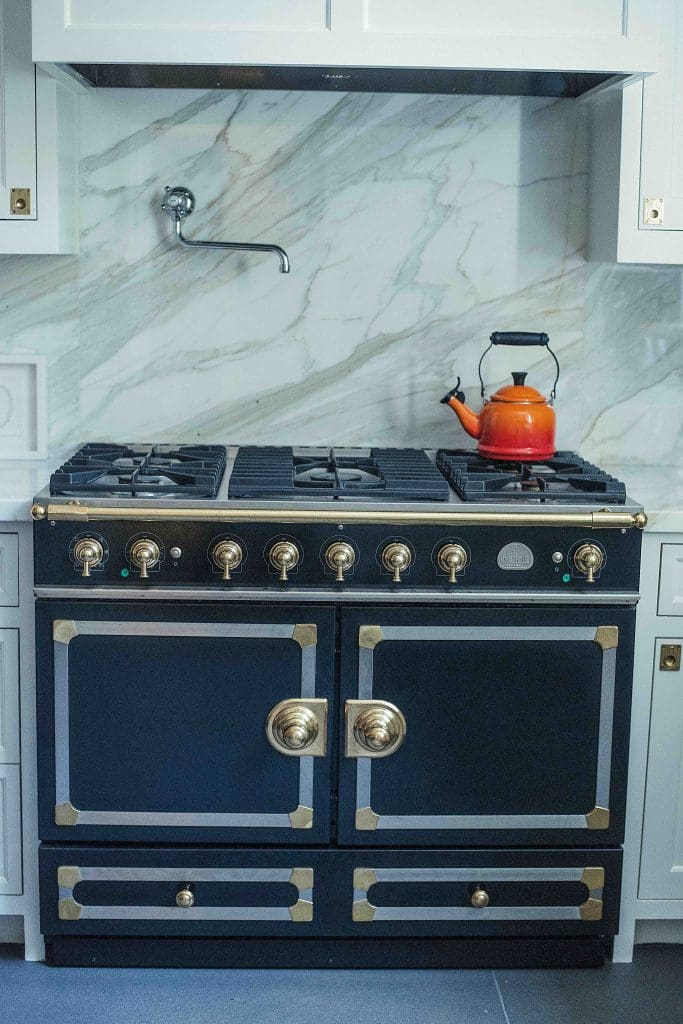 La Cornue Fe 110 Stove; Mounted Rohl pot filler, and Calacatta Borghese marble backsplash