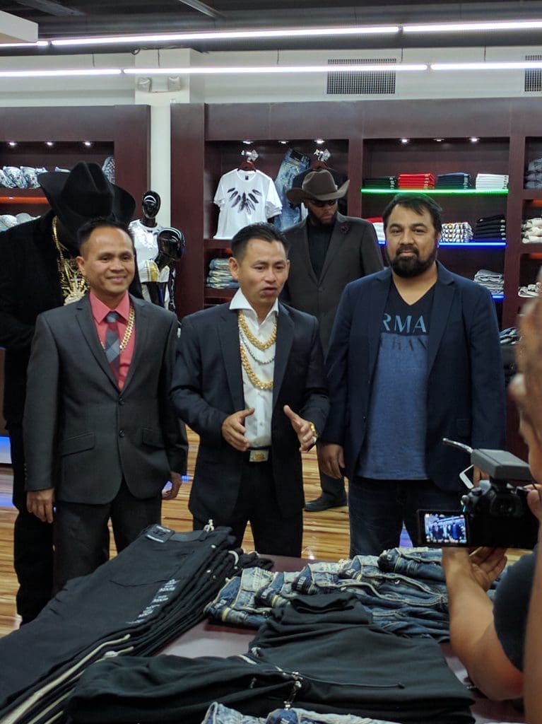 Johnny Dang with business partners on the floor of his new men's boutique. 
