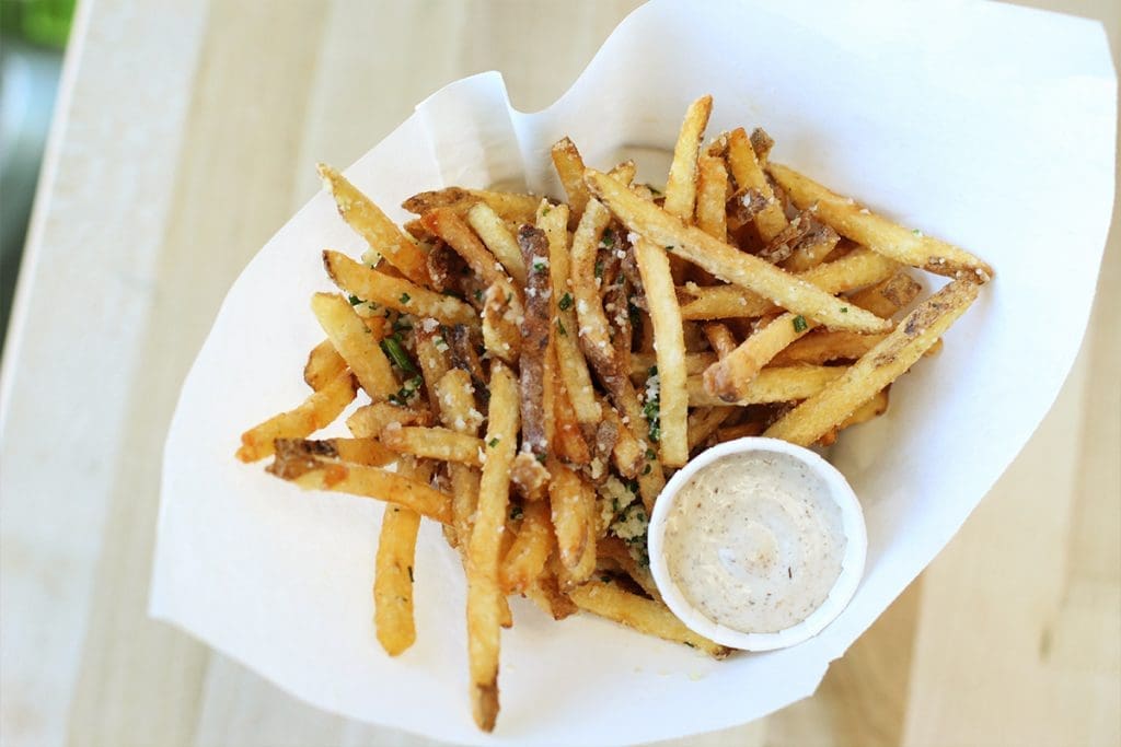 No Hopdoddy burger is complete without parmesan truffle fries. Fries topped with green chile queso and chili con queso are also available. 