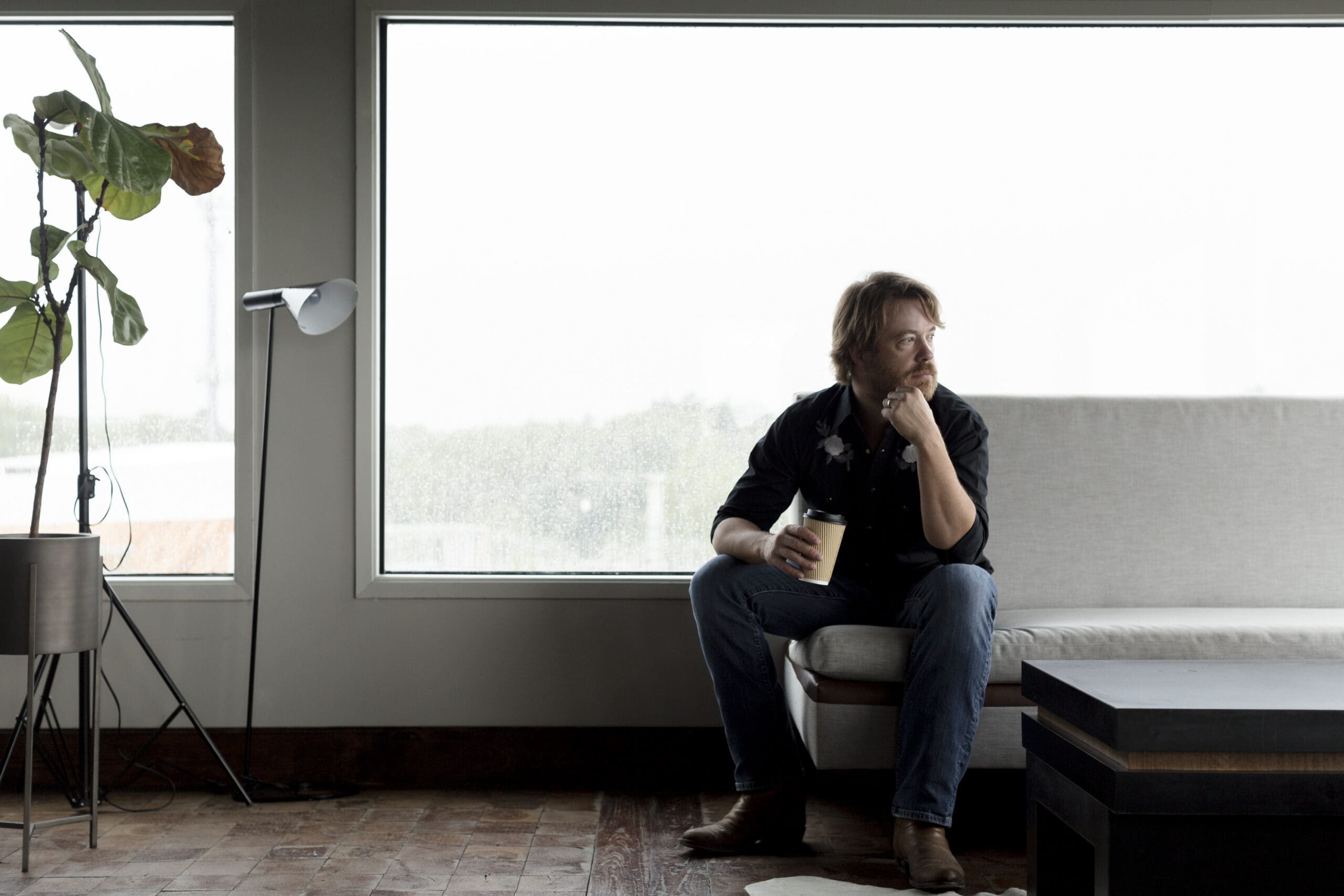 Will Thomas relaxes for a moment at the top of White Oak Music Hall's Raven Tower.