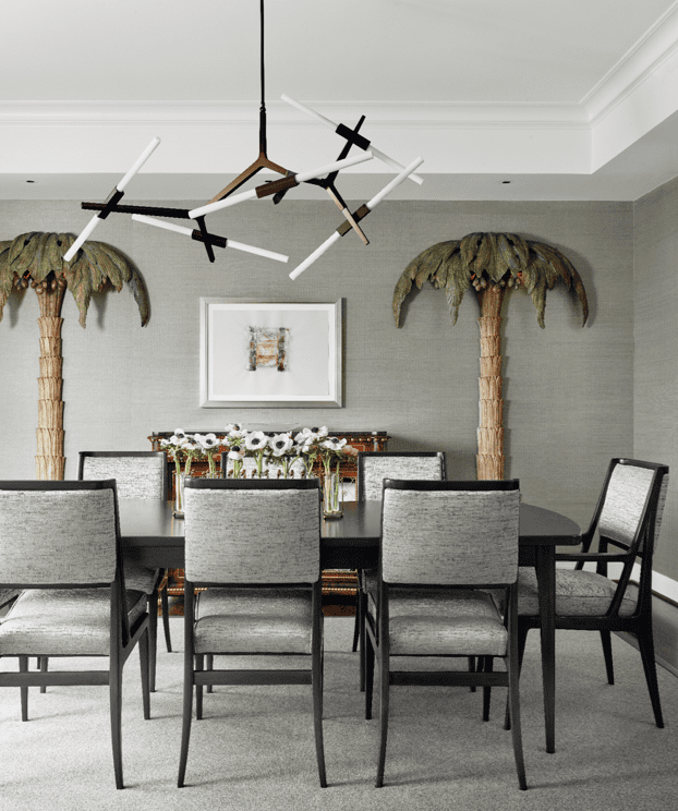 In the dining room, Singer & Sons table and chairs, attributed to Gio Ponti and Bertha Schaefer. Lindsey Adelman Studio light fixture. Artwork Marilyn Baum. Vintage palm-tree floor lamps by Maison Jansen.