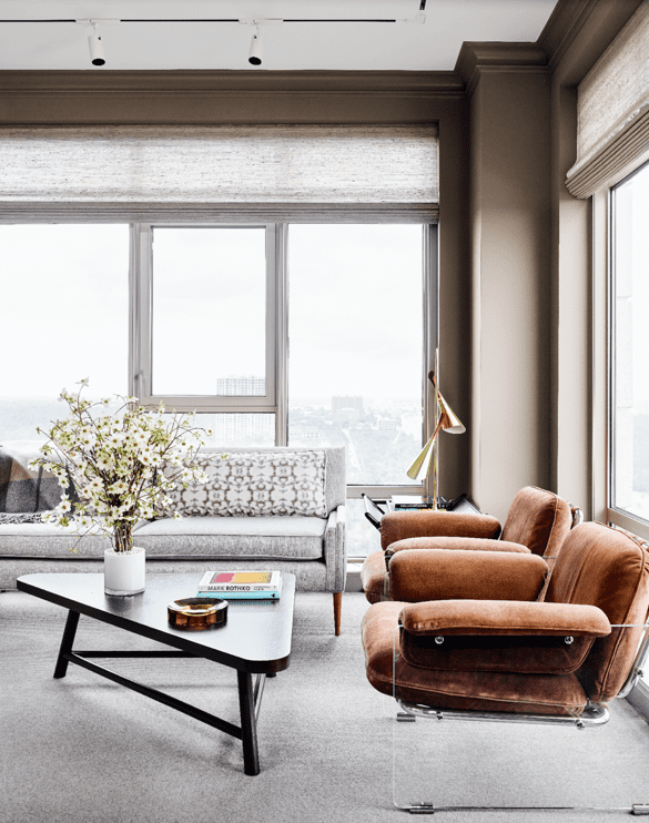 In the study, vintage Paul McCobb sofa with Zimmer + Rohde fabric from George Cameron Nash. Vintage Pace Collection Lucite-and-suede chairs. Vintage T.H. Robsjohn-Gibbings triangle table. 1950s brass lamp. Conrad window coverings from The Shade Store.