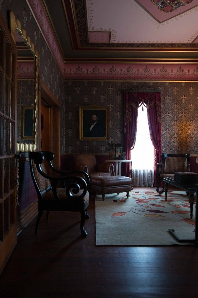 Front-parlor ceiling is hand-painted. Crocodile-leather-print club chair from David Sutherland. Rosemary Hallgarten rug. Antique painting is a flea-market find.