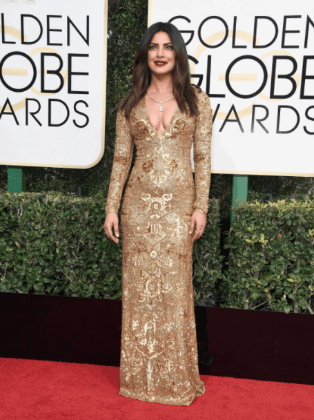 Multitalented actress Priyanka Chopra's inspires us with her gilded-baroque Ralph Lauren gown. Way to pay homage to her Bollywood roots. 