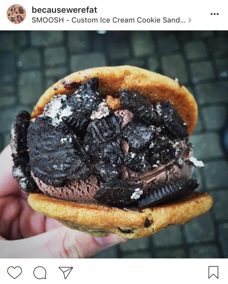 Chocolate ice cream sandwiched between two freshly baked chocolate chip cookies, adorned with oreo crumbs from SMOOSH
